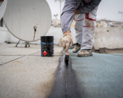 Roll roofing Installation with propane blowtorch during construction works